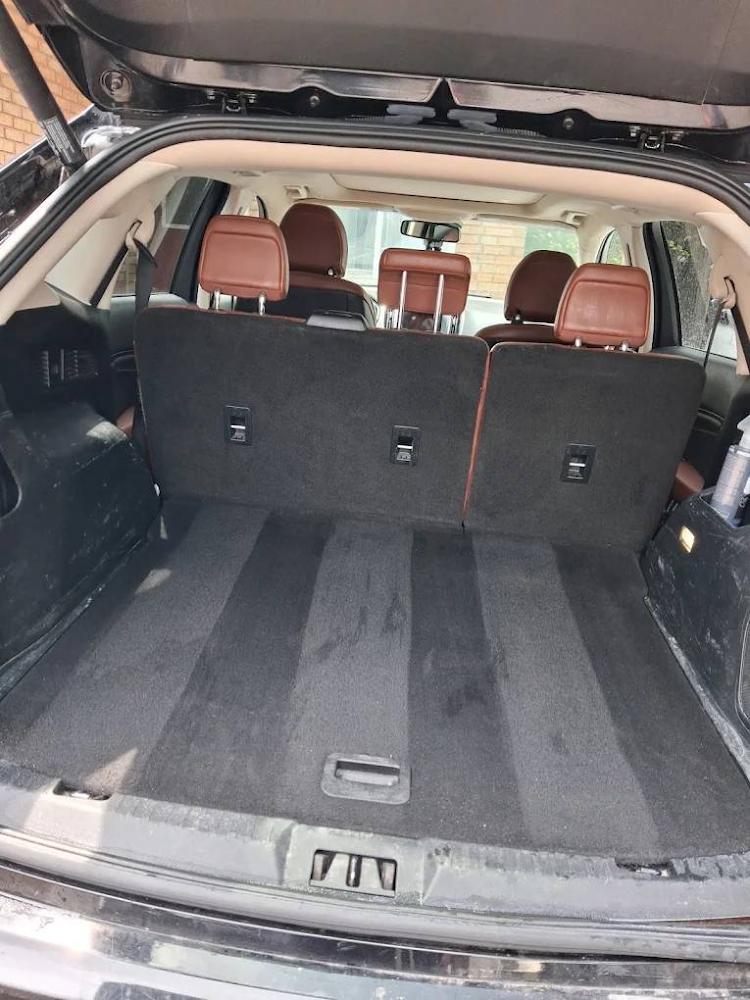 An SUV cargo area after a full interior detail, with clean carpet and spotless trim