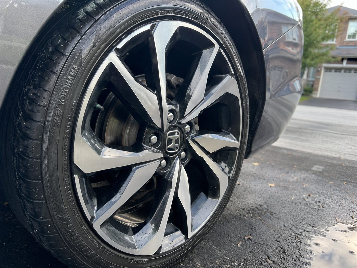 Close-up of a detailed alloy wheel with dressed tire and mirror-clean spokes